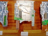 PlayStation 5 1200型号主板（中间）及其前身（来源：Austin Evans on YouTube）。