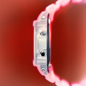 卡西欧G-Shock DW-5600TNT-7的侧视图,展示了其半透明表壳和金属按钮。