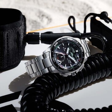 Lifestyle image of the Citizen Promaster Wave Tracker JV3001-53E resting beside black sailing gear and marine accessories.