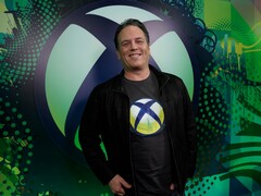 微软游戏首席执行官菲尔-斯宾塞站在 Xbox 背景板前（图片来源：Xbox Wire）
