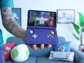 Retro Game Corps 的 Russ 手持紫色 Retroid Pocket Flip 2 掌上游戏机，屏幕显示世嘉创世纪模拟器界面。(图片来源：YouTube 上的 Retro Game Corps）