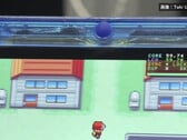 透明蓝色 FPGBA SP 掌机运行 Pokémon 的特写，可见 59.74 FPS 计数器。