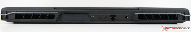 背面。XMG OASIS插槽（带盖），USB-C 3.2 Gen 2×1（DisplayPort 1.4a），HDMI 2.1（兼容G-SYNC，HDCP 2.3），RJ45端口2.5 Gb/s（LAN），AC适配器