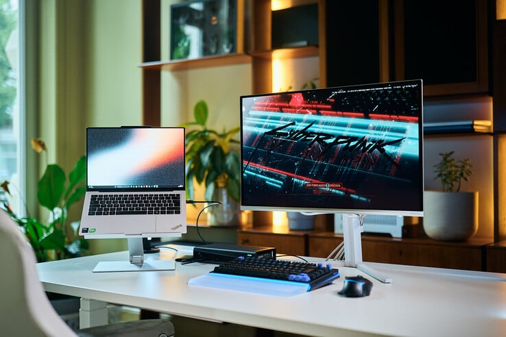 一套完整的工位配置,包括放置在支架上的ThinkPad X9 14笔记本电脑、Aorus RTX 5060 Ti AI Box外接显卡,以及正在运行《赛博朋克2077》的外接显示器。